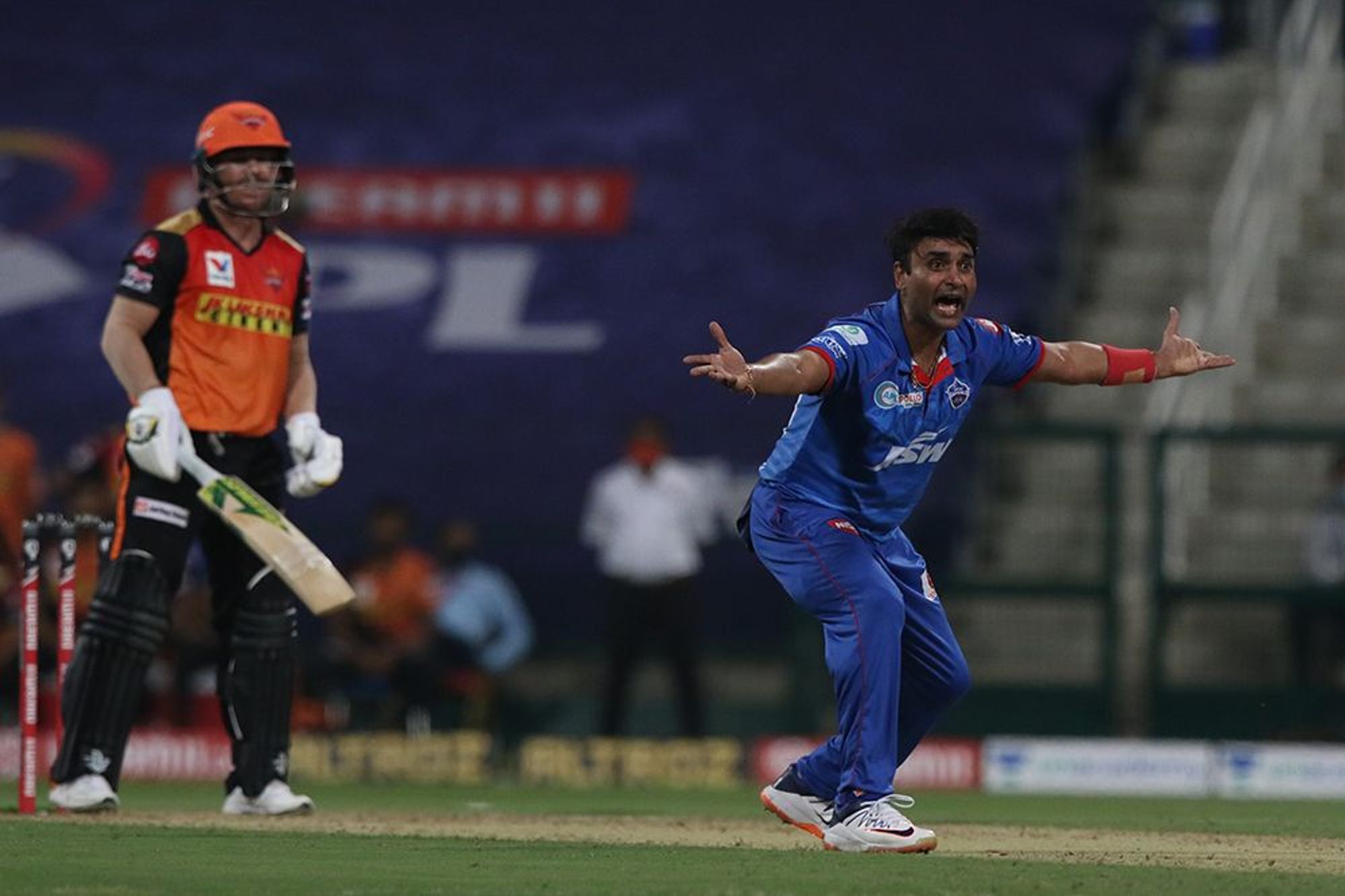 Amit Mishra applies saliva to ball